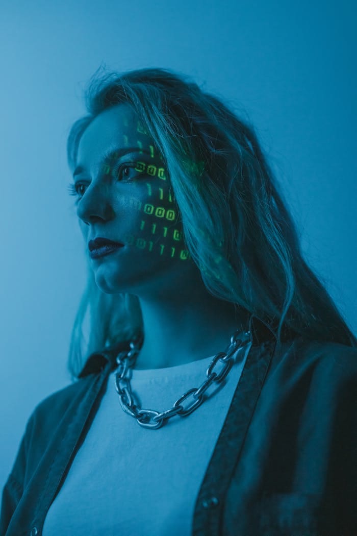 services-02 Woman with illuminated binary code on her face, artistic tech concept.